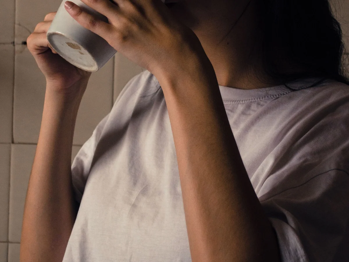 Woman preparing an afternoon caffeine-free drink at her desk