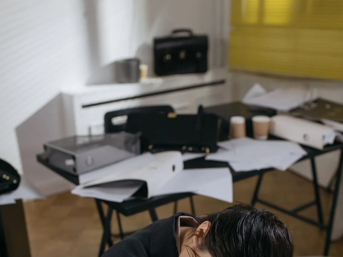 Woman reviewing a fatigue log at a kitchen table