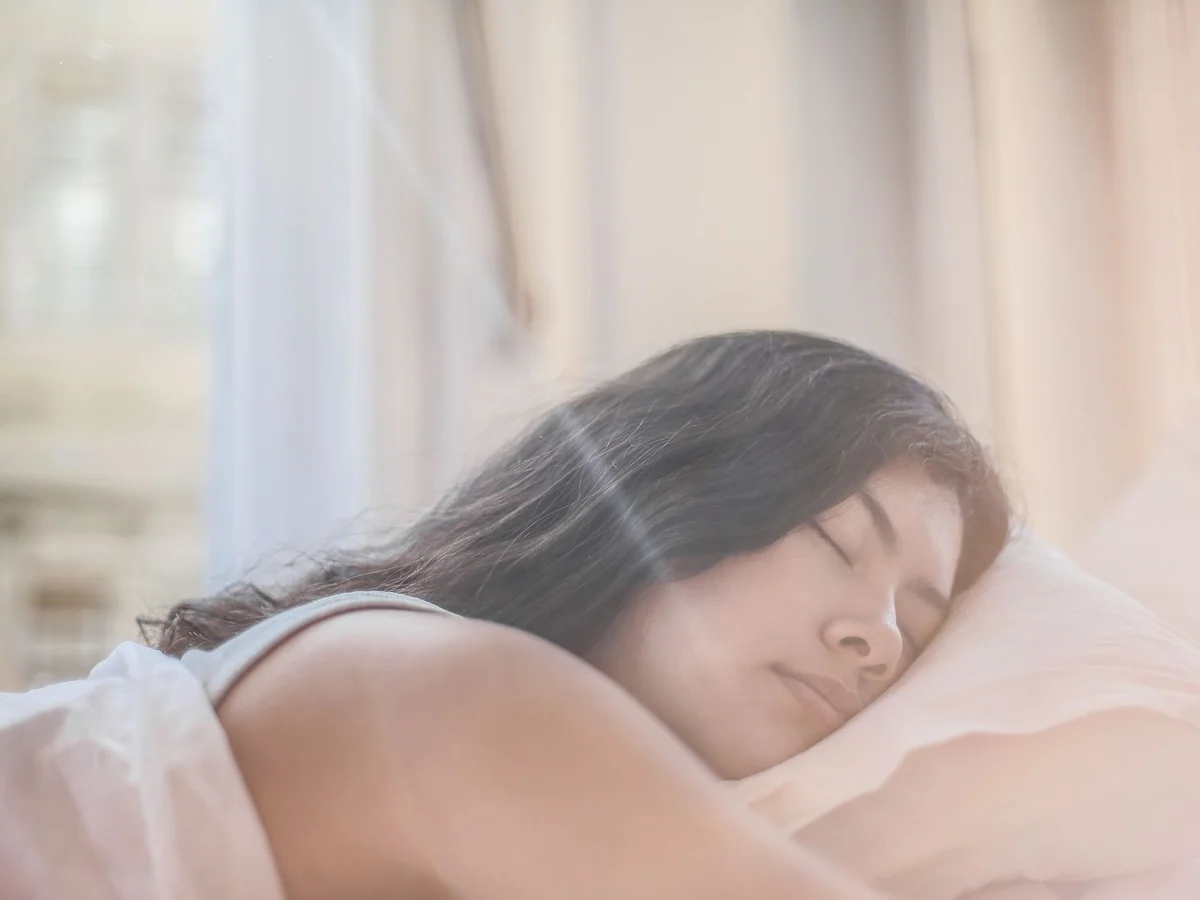 Shift worker preparing a dark bedroom for daytime sleep